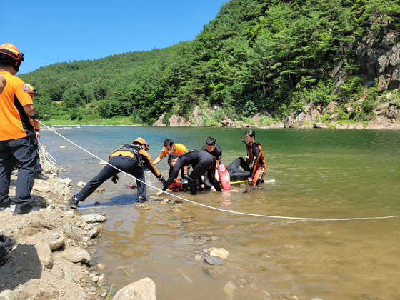1일 낮 강원 삼척시 내평계곡에서 물에 빠진 20대 남성을 구조대원들이 구조하고 있다.〈사진=강원 삼척소방서 제공〉