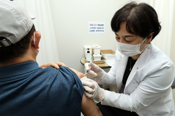 지난달 13일 서울의 한 보건소 건강센터에서 어르신이 코로나19 백신 4차 접종을 하는 모습. 〈사진-공동취재단〉