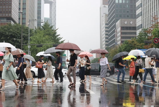 어제(11일) 오전 서울 광화문네거리에서 시민들이 우산을 쓴 모습. 〈사진-연합뉴스〉 